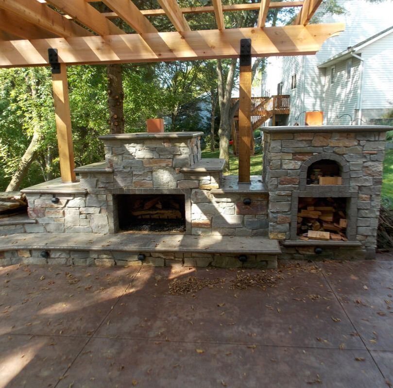 outdoor living area with fireplace and pizza oven in Cold Spring Minnesota