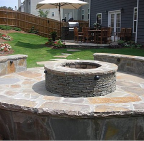 Firepit stamped concrete patio with stone sitting wall 